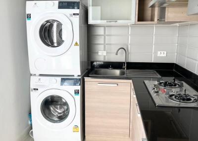 Compact modern kitchen with stacked washer and dryer