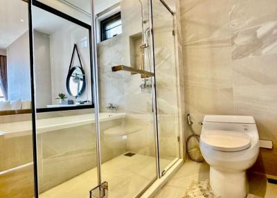 Modern bathroom with glass shower enclosure and large mirror