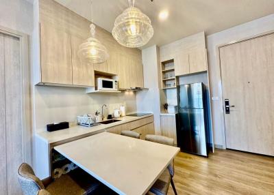 Modern kitchen with integrated dining area and stainless steel appliances