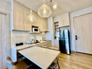 Modern kitchen with integrated dining area and stainless steel appliances