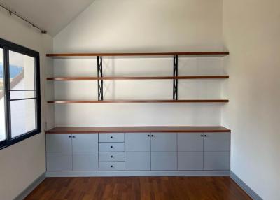 Minimalist bedroom with spacious shelving and modern storage cabinets