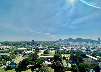 Panoramic aerial view from a high-rise showing the cityscape and clear blue sky