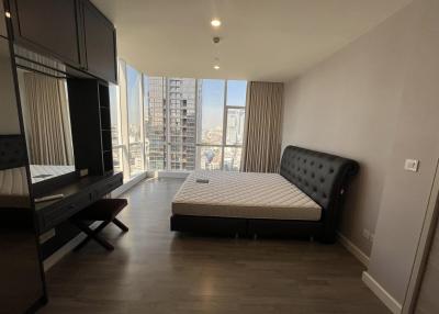 Modern bedroom with large windows and city view