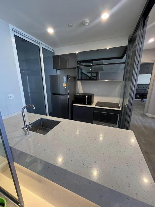 Modern kitchen with stainless steel appliances and quartz countertop