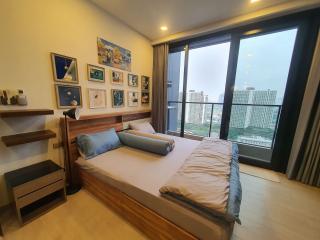 Modern bedroom with large window and city view