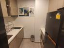 Modern and compact kitchen with fridge and wall art