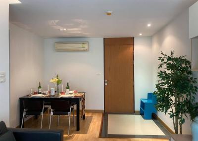 Modern dining room with set table and indoor plants