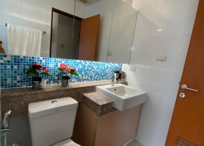 Modern bathroom with mosaic tile accent wall