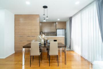 Modern kitchen with wooden cabinetry and dining area