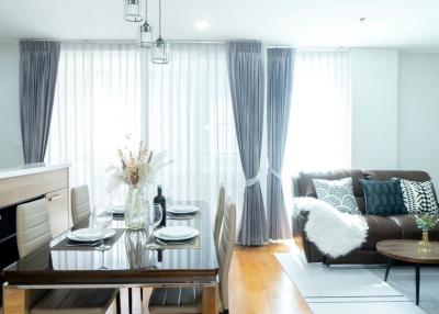 Modern living room and dining area with natural light