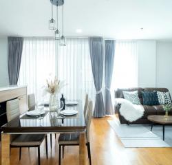 Modern living room and dining area with natural light