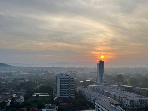 Sunset view over a cityscape showing residential and commercial buildings