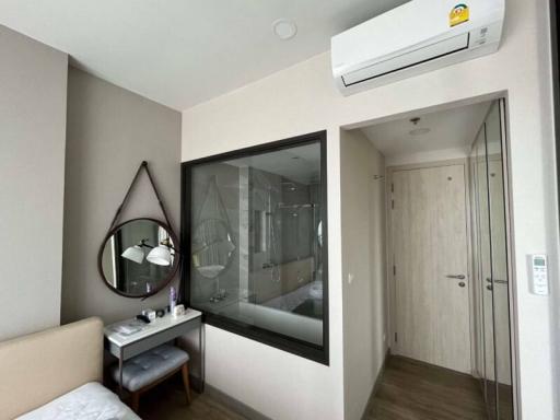 Modern bedroom interior with a view of the en-suite bathroom