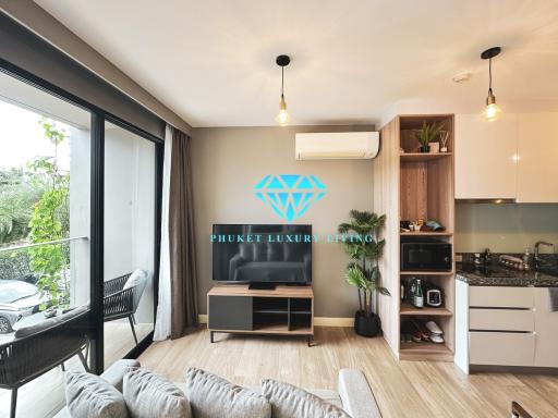 Modern living room with connected kitchenette and balcony access