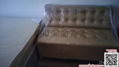 New upholstered bed wrapped in plastic with QR codes and contact numbers