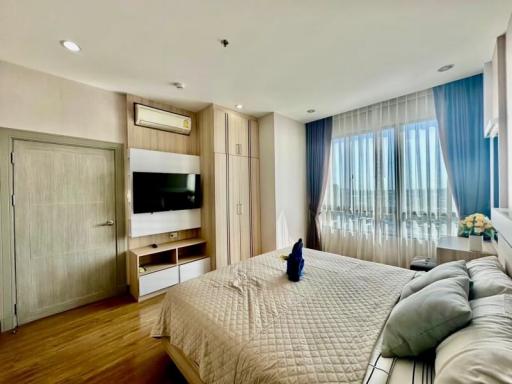 Modern bedroom with ample natural light and a large bed