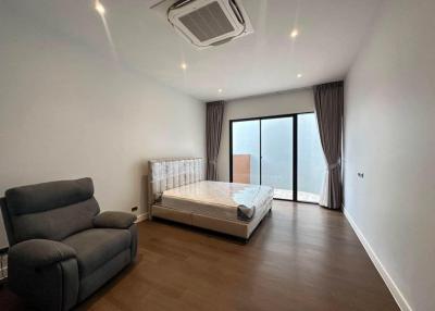 Spacious bedroom with modern furniture and ample natural light