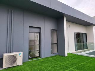 Modern exterior of a residential building with green lawn