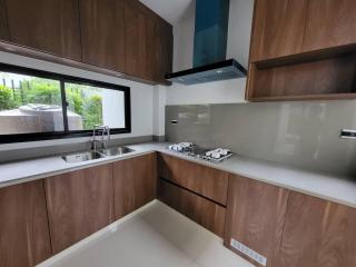 Modern kitchen with wooden cabinets and stainless steel appliances