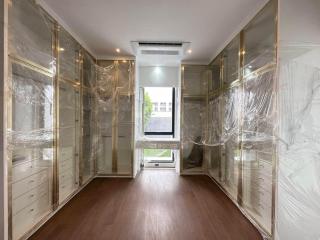 Spacious bedroom with mirrored closet doors and hardwood floors
