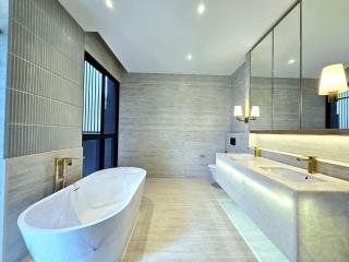 Spacious modern bathroom with freestanding bathtub and double vanity