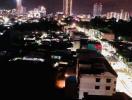 Cityscape at night showing illuminated buildings and streets