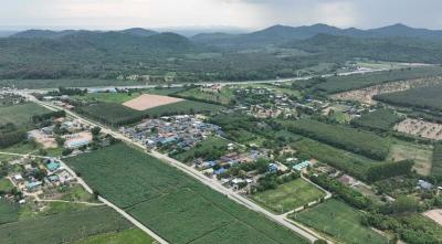 Aerial view of a rural landscape with community, fields, and mountains