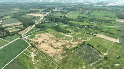 Aerial view of potential development land with surrounding greenery and roadways