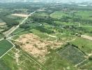 Aerial view of potential development land with surrounding greenery and roadways