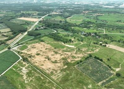 Aerial view of potential development land with surrounding greenery and roadways