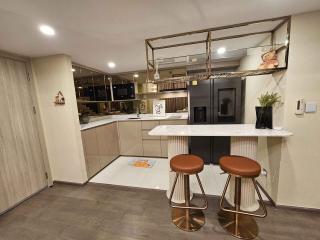 Modern kitchen with bar stools and integrated appliances