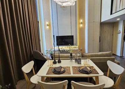 Modern dining area with stylish furniture and elegant lighting