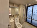 Modern bathroom with glass shower and beige tiles