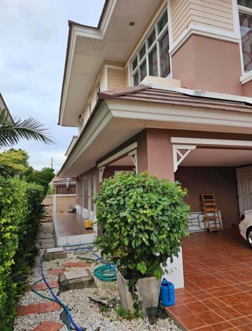 Front view of a two-story residential home with a carport