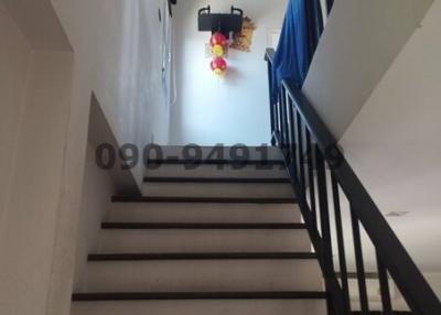 Staircase area with handrails leading to the upper floor of a house