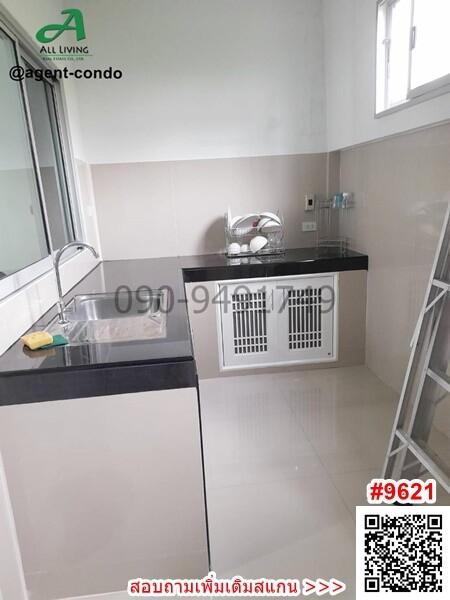 Modern small kitchen with white cabinetry and stainless steel sink