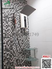 Modern bathroom with wall-mounted shower and black-and-white tiles