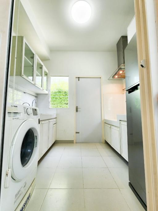 Modern kitchen with washing machine and ample storage space