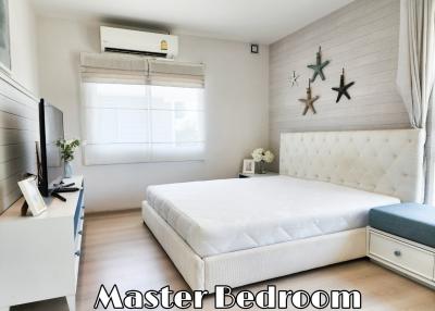 Spacious master bedroom with large bed and modern decor