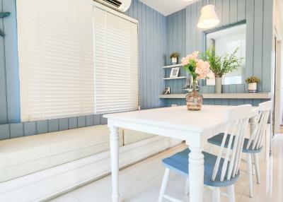 Bright and modern dining room interior with white furniture and blue accents