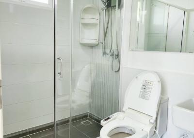 Modern bathroom with glass shower and white fixtures