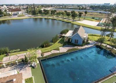 Aerial view of a luxurious house with swimming pool and pond
