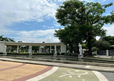 Elegant courtyard area with statues and well-maintained gardens