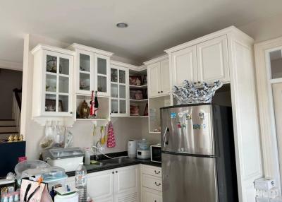 Spacious kitchen with white cabinets and modern appliances