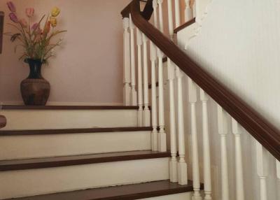 Elegant staircase with wooden banister and white balusters