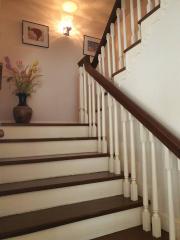 Elegant staircase with wooden banister and white balusters