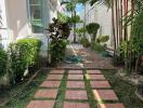 Paved Pathway Leading to a Cozy House Garden with Greenery