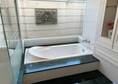 Spacious bathroom with a large tub and elegant marble details