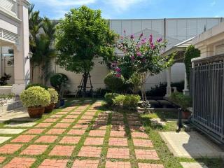 Well-manicured backyard garden with greenery and walkway