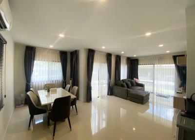 Spacious and modern living room with dining area and glossy tiled flooring